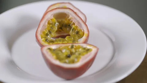Three parts of passion fruit. Rotating on the turn table. Isolated on white Stock-Footage 92016134
