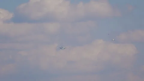 Three passenger airplanes in queue for landing in cloudy sky Video stock 342450961