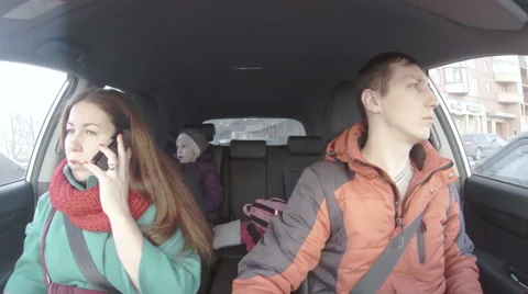 Three passengers of car while driving. Two adults and kid on backseat, 4k Stock Footage 48032499