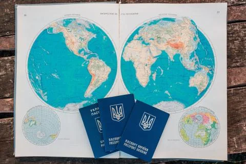 Three passports on the background of the world map. Stock Photos