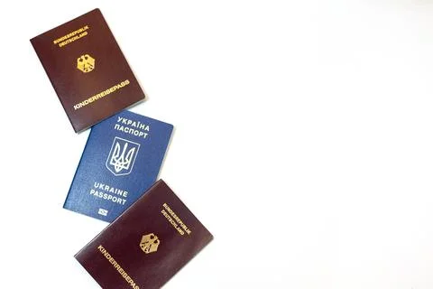 Three passports displayed on a white background representing international Stock Photos