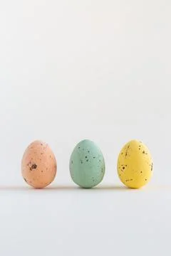Three pastel colored chocolate Easter eggs, one pink egg sharp, on white back 写真素材