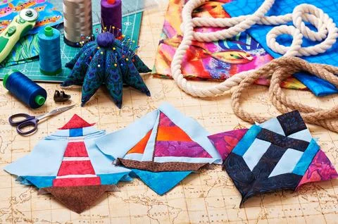 Three patchwork blocks lighthouse, yacht and anchor, quilting tools and acc.. Fotos de archivo