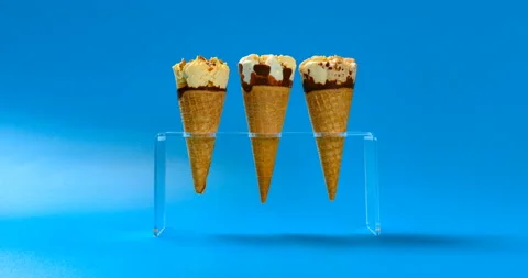 Three pcs ice cream cones melting on blue timelapse at 8K Stock Footage