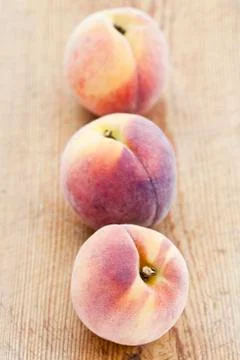 Three peaches in a row Фото