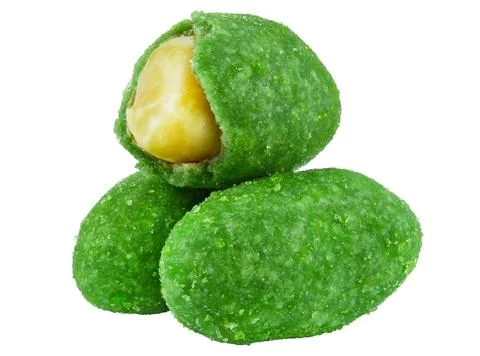 Three peanuts in wasabi glaze isolated on a white background. Close-up. Stock Photos
