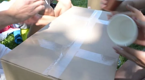 Three people are playing with paper cups, beat out the rhythm and clap hands Stock Footage 66056532