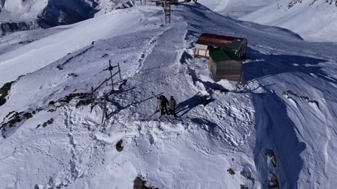 Three people are standing on the top of mountain. Gudauri ski resort in winter. Stock Footage 315735110