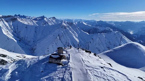 Three people are standing on the top of mountain. Gudauri ski resort in winter. Stock Footage 315735268