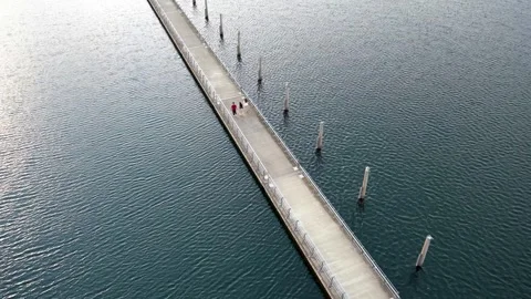 Three people are walking on a bridge Stock Footage 340519962