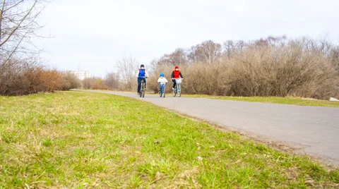 Three people on bikes in the park Stock Footage 37204899