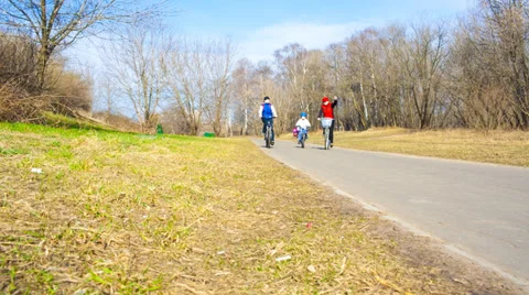 Three people on bikes in the park Stock Footage 37204984