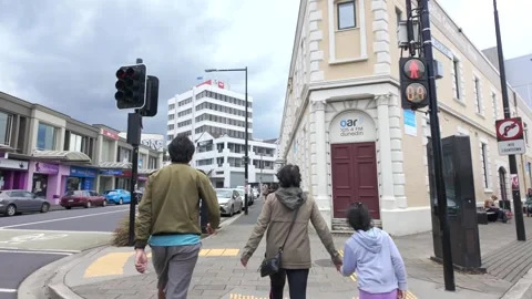 Three People Crossing a Road Stock Footage 325919184