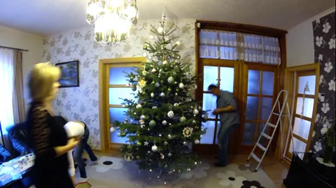 Three people decorate a christmas tree timelapse Stock Footage 36645392