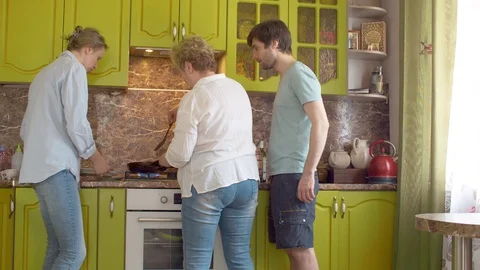 Three people frying pancake Video stock 128920864