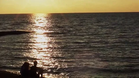 Three people looking to the sunset. Video stock 95438321