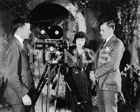 Three people with movie camera Stock Photos