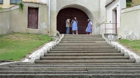 Three people out of a yard through a gate semiround. Stock Footage 69833214