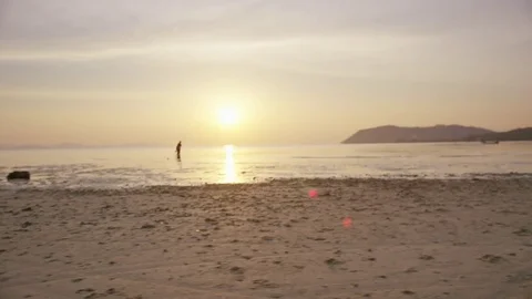 Three people performing yoga on beach at sunset Stock-Footage 75291325