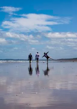 Three people playing on a beach Stock Photos