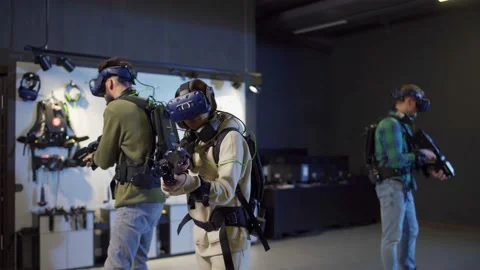 Three people playing hi-tech VR game Stock Footage 141259955