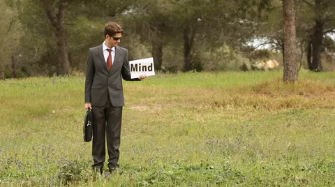 Three people with self made signboard and the word puzzle mindfulness Stock Footage 62259804