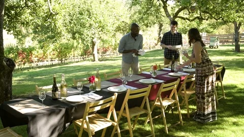 Three people setting a table 動画素材 77083071