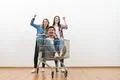 The three people with a shopping cart gesture on a white wall background Photo