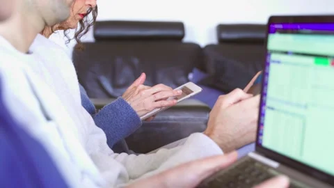 Three people sitting and using tablet, smartphone and laptop Stock Footage 266717820
