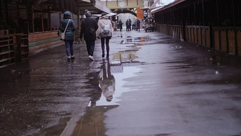 Three people walk between the trading pavilions. Stock Footage 73923170