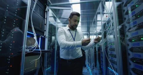 Three people working in a data center with cable Stock Photos