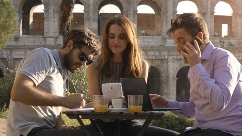 Three people working together on a project with laptop and tablet writing Stock Footage 90767230