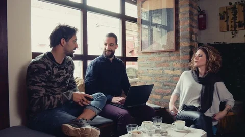 Three people working while sitting in a cafe Stock Footage 95906640