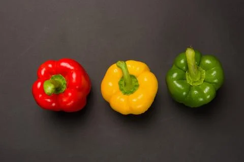 Three peppers on black background Stock Photos