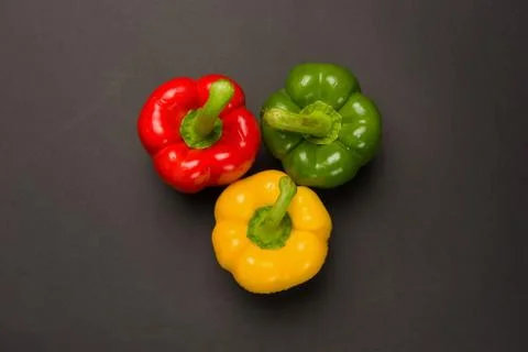 Three peppers on black background Stock Photos