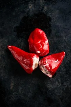 Three peppers on dark tray Stock Photos