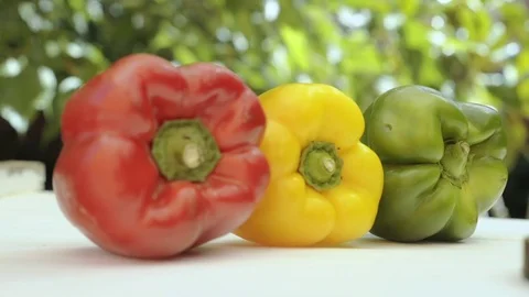 Three peppers, one red, one green and one yellow. rack focus, Stock Footage 78175475
