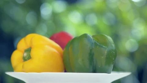 Three peppers, one red, one green and one yellow. Seamless Looping Video stock 78175490