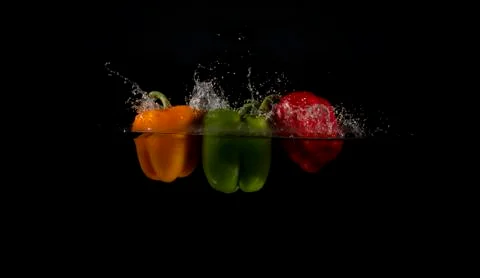 Three peppers splashed into water 写真素材