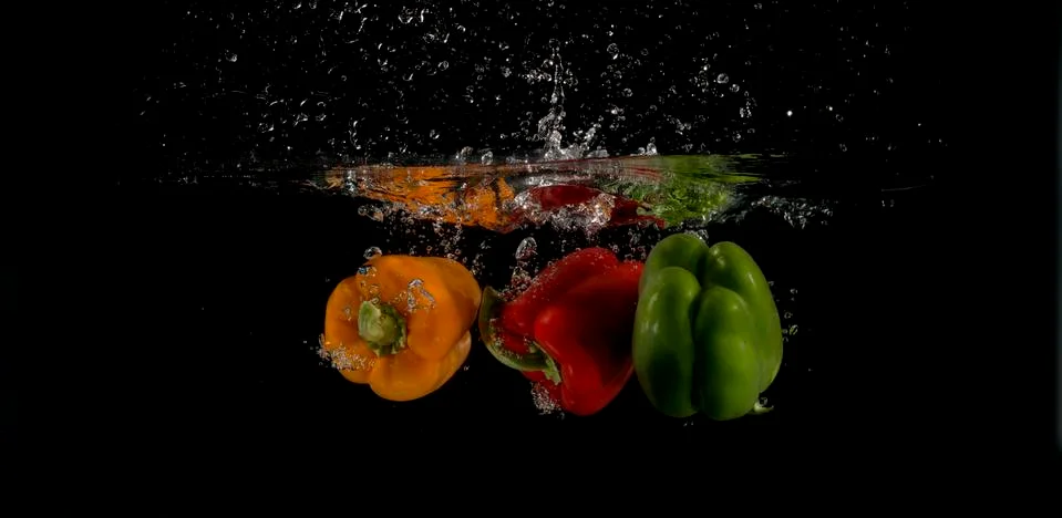 Three peppers splashed into water 写真素材