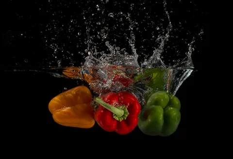 Three peppers splashed into water 写真素材