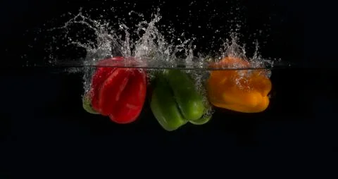 Three peppers splashed into water 写真素材