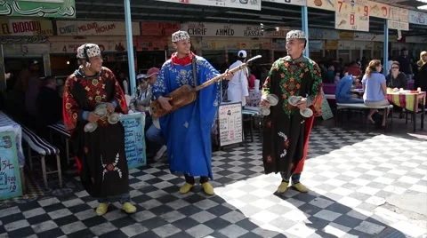 Three performers dancing and playing the traditional Moroccan Gnawa music Stock Footage 44783022