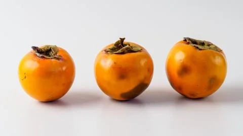 Three persimmon isolated on white background. Foto stock