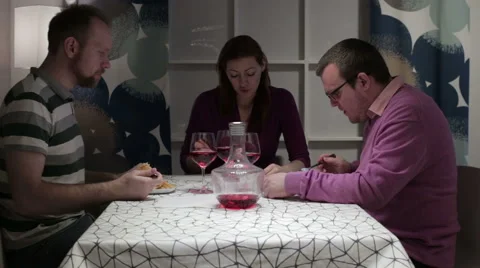 Three person having dinner at the table Stock Footage 62793983