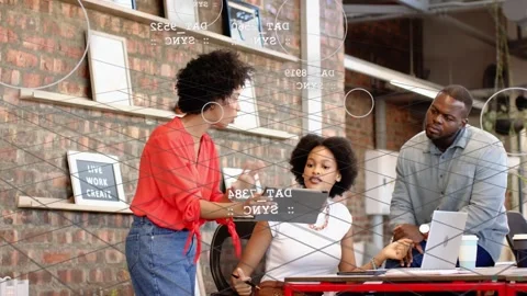 Three-person team meeting, presenter showing tablet, data graphics marking Stock Footage 333975401