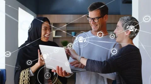 Three-person team working on project at laptop in nook, woman tapping pad, tech Stock Footage 334184920