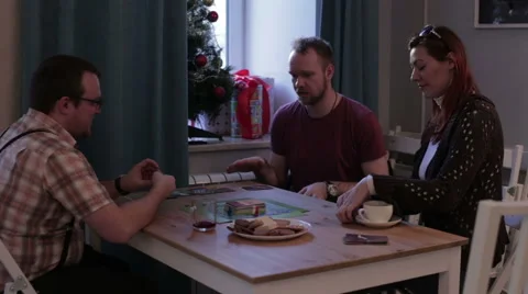 Three persons playing a board game with cards Stock Footage 62766833