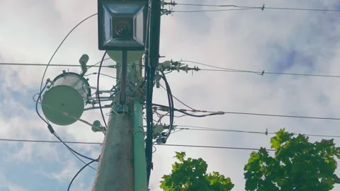 Three Phase Pole Mounted Transformer Bank with Street Light Under Cloudy Sky 動画素材 347247404