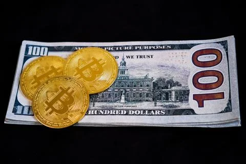 Three physical golden Bitcoin token coins arranged overlapping on the left .. Stock Photos